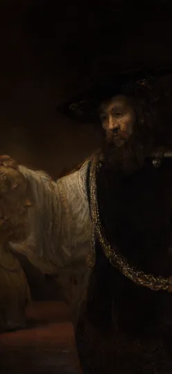 A bearded man in a black hat and a heavy gold chain rests one hand on a marble bust.