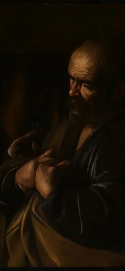An old man, lit from one side, gestures toward himself while a woman and a soldier in a helmet turn to him.